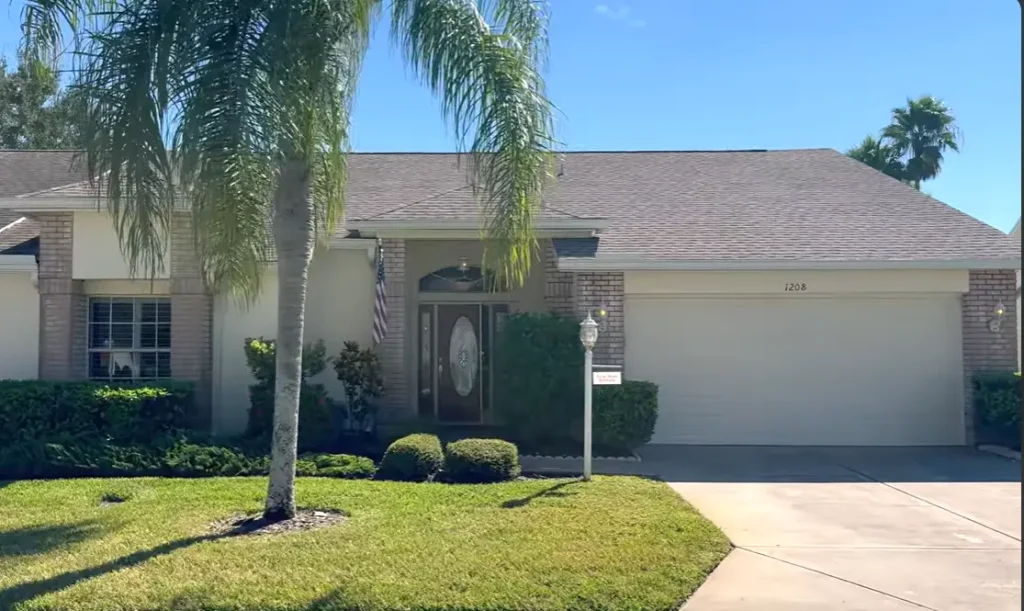 Beige residential home in Gainesville featuring a professional asphalt shingle roof installation