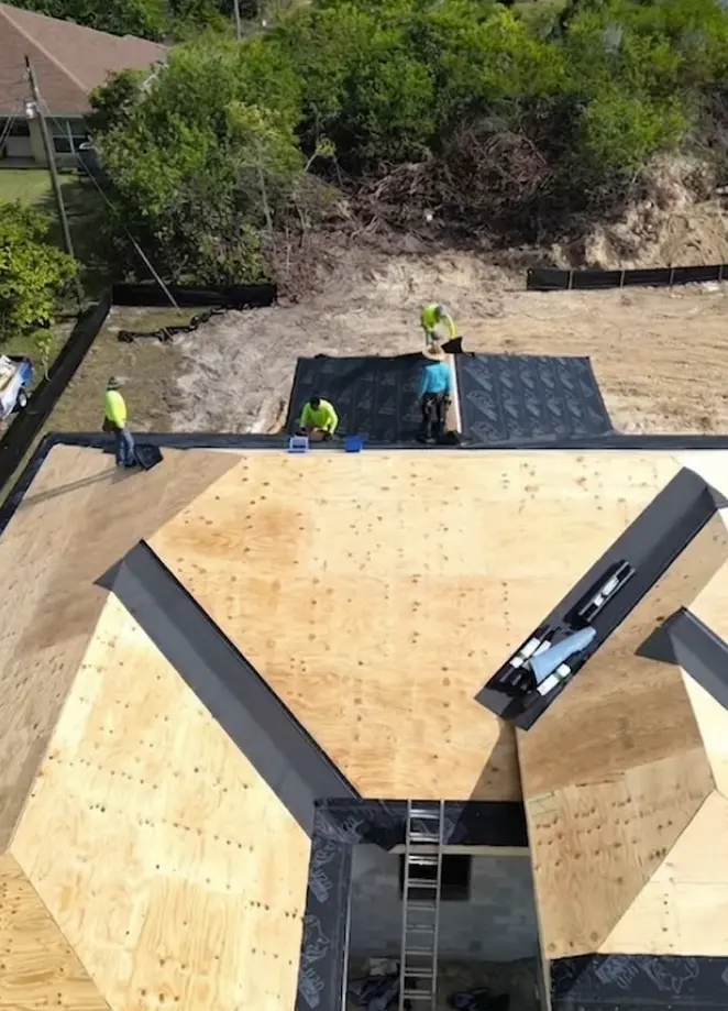 Professional roofing crew installing high-quality underlayment on a residential home
