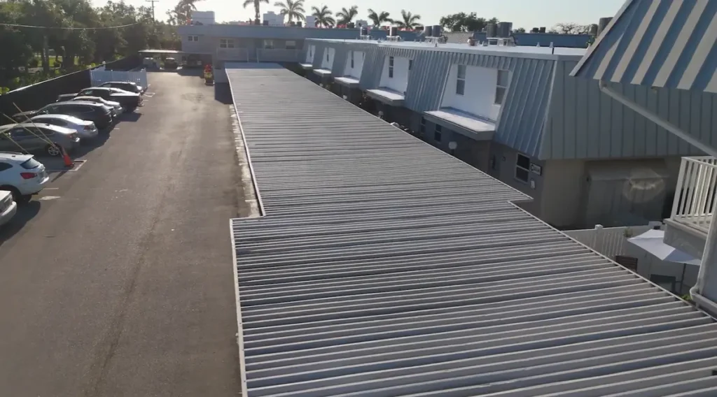 Long commercial property protected by a newly installed gray ribbed metal roof.