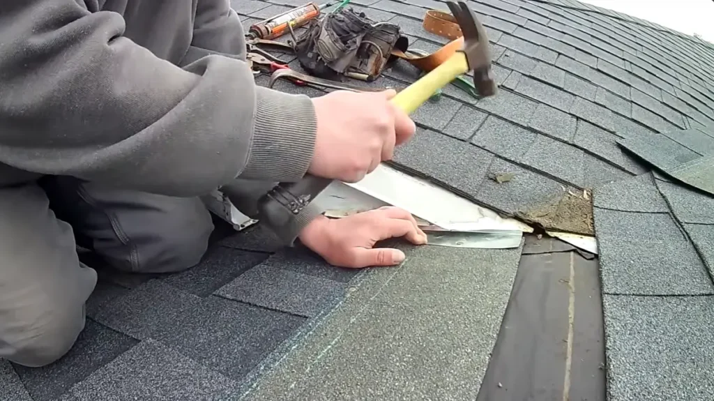 Professional roofer repairing damaged shingles during an emergency roof service in Gainesville.