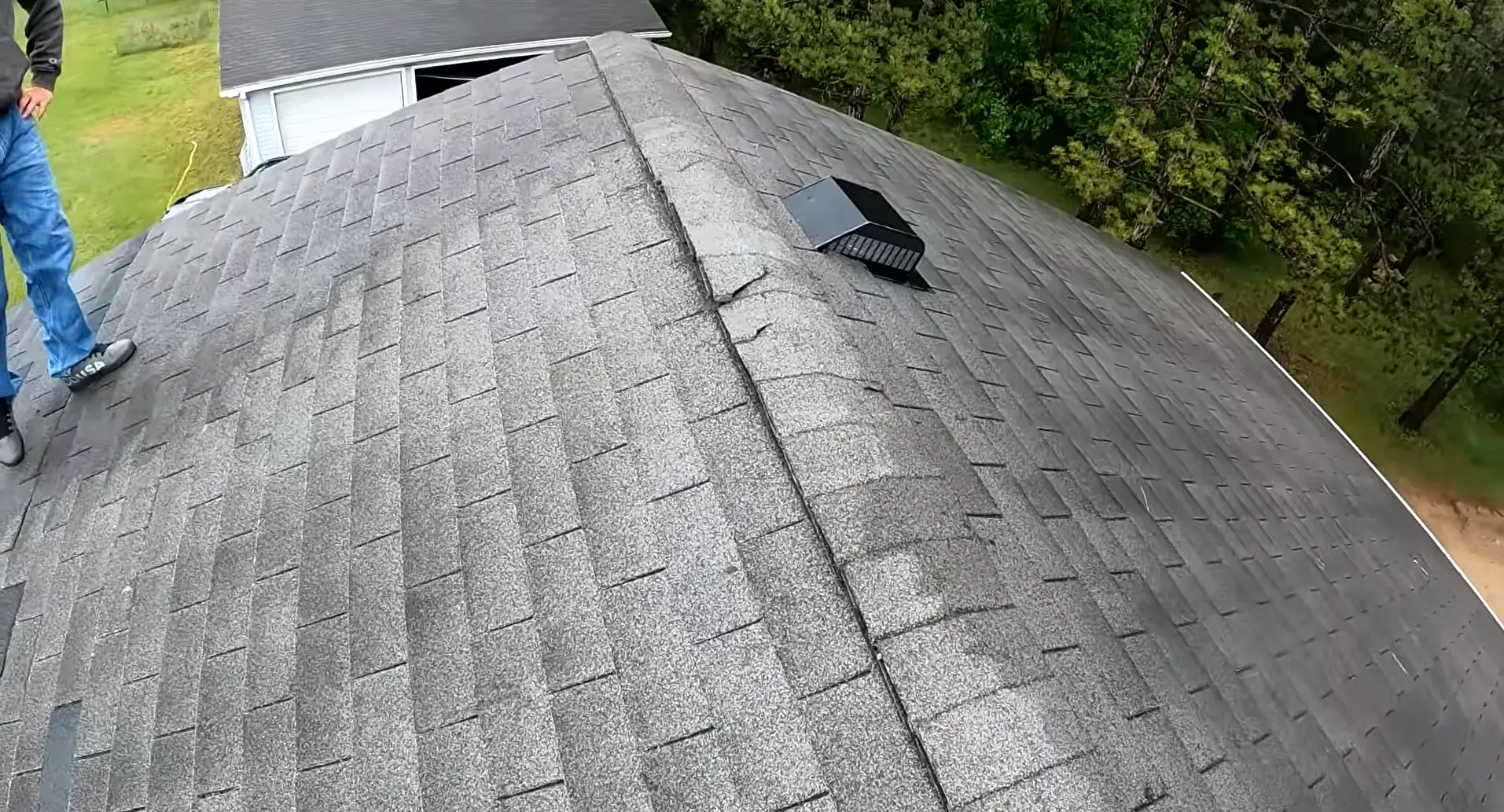 Visible Shingle Deterioration and Granule Loss on an Aged Roof