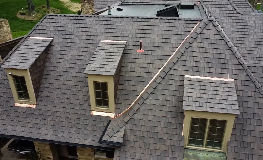 A premium residential synthetic composite slate roof with copper flashing in North Florida