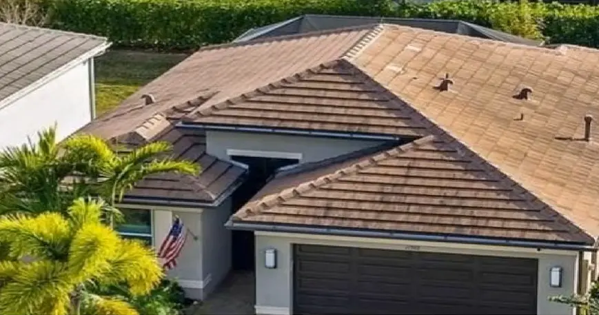 Detailed view of tan interlocking roofing tiles on a residential home.
